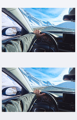 snowy mountains road view from the modern luxury car interior with drivers hand on steering wheel