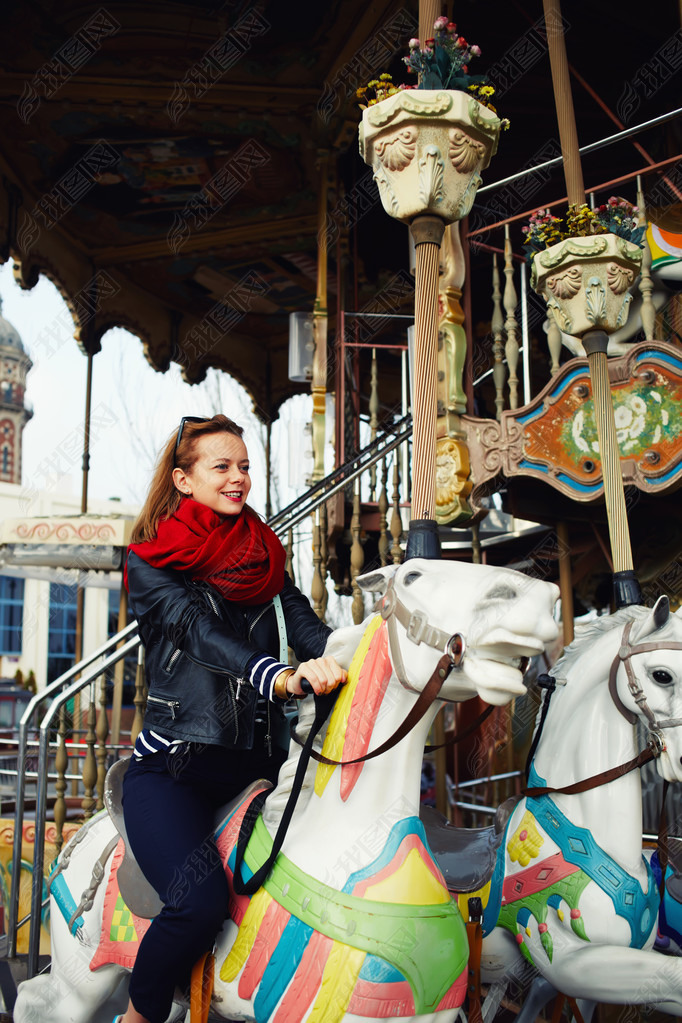 woman riding on a merry go round