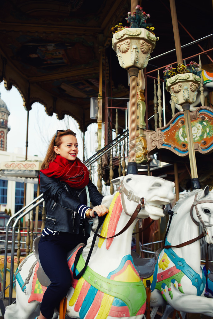 woman riding on a merry go round