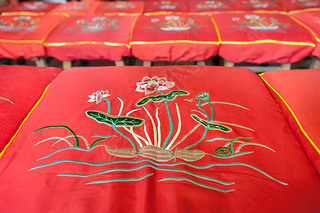 Lotus flower pattern on a red prayer cushion at a Chinese temple