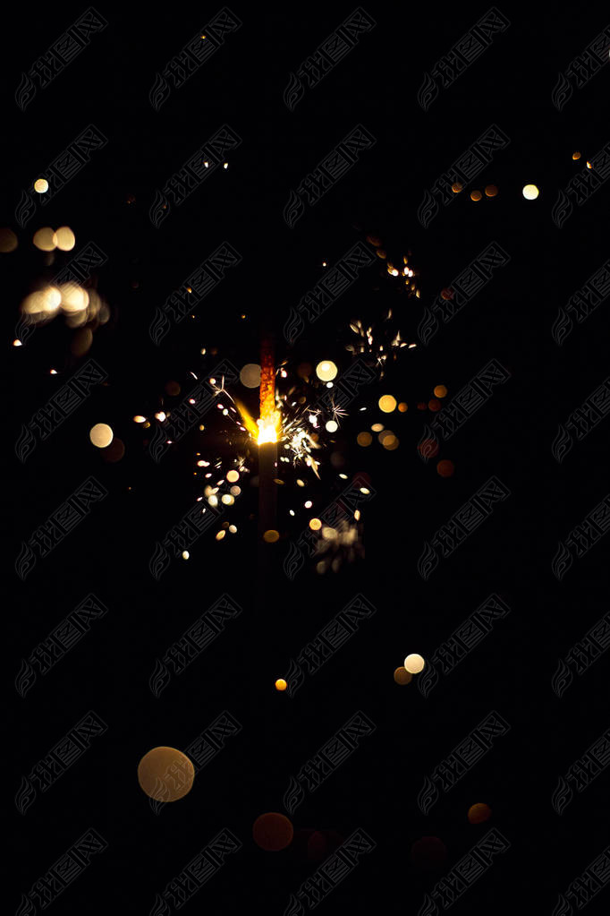 Glowing flow of sparkler, bokeh shine in the dark background