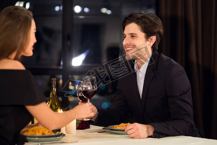 Happy man toasting with his beloved girlfriend during dinner
