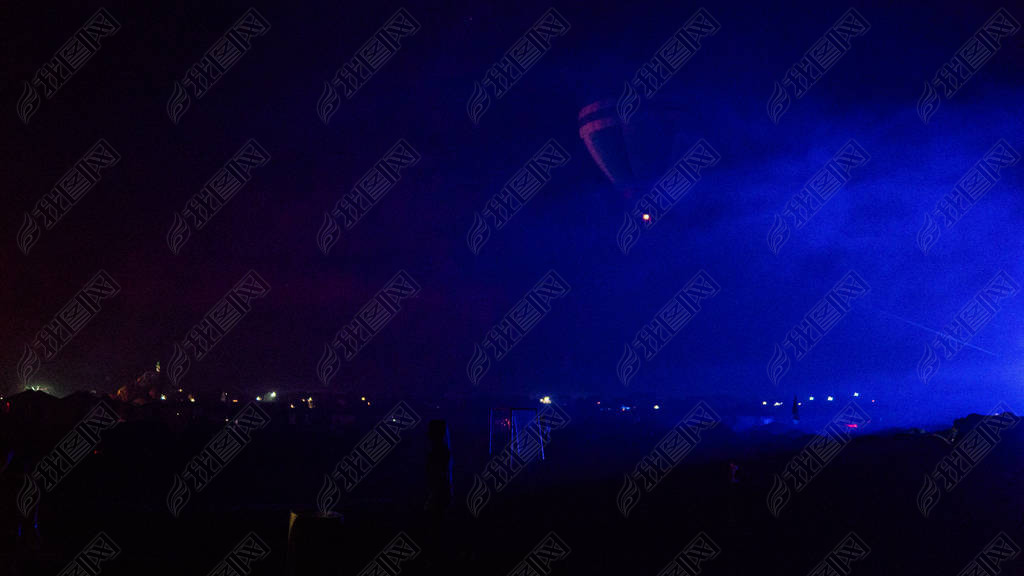 Hot air balloon flying over spectacular Cappadocia under the sky with milky way and shininng star at