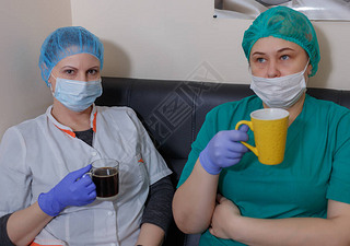 A female doctor in a sterile mask and uniform on a break during the covid-19 coronavirus pandemic