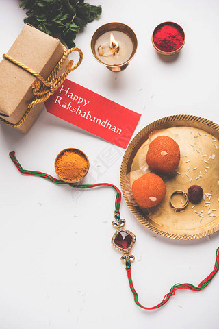 Raksha Bandhan / Rakshabandhan Rakhi with Haldi Kumkum rice, sweet Mithai, Gift Box, selective focus