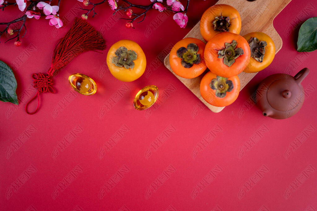 Top view of fresh sweet persimmons kaki with leaves on red table background for Chinese lunar new ye