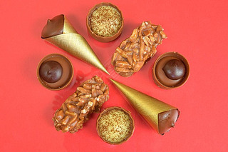 Top view of various chocolate pralines on pastel background. Top view of variety chocolate pralines.