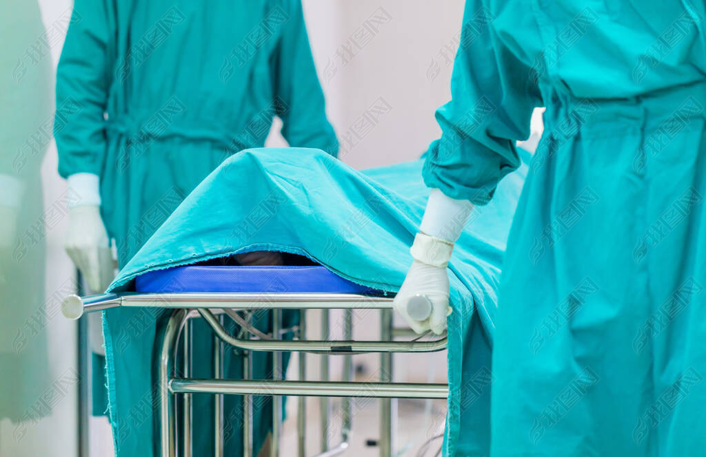 Selective focus of medical team moving patient to surgery in the operating room at the hospital