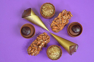 Chocolates praline variety on pastel background with copyspace. Assortment of fine chocolate candies