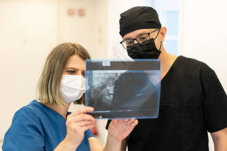 Two doctors checking x-ray image in hospital, high quality photo