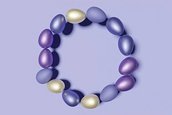 3d render of pastel colored Easter eggs wreath on a violet color of the year 2022 background