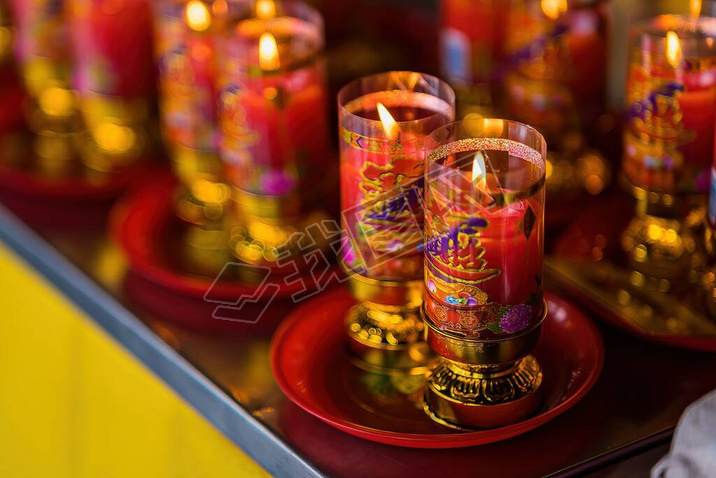Bangkok, Thailand - December, 20, 2021 : Praying and meditation with burning candle on Chinese templ