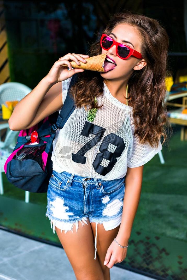 woman in sunglasses eating ice cream