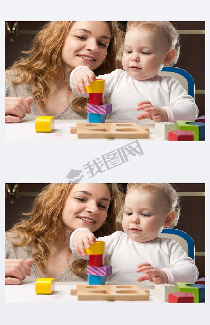 Mother and baby daughter building tower