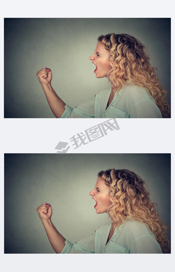 Angry woman screaming with fist up in air 