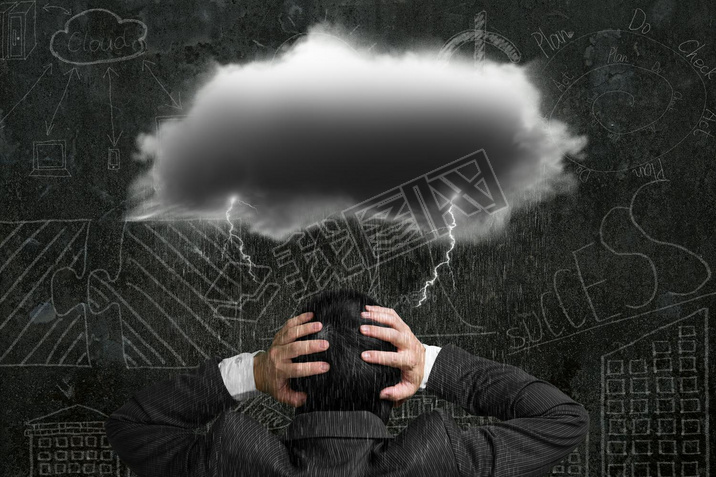 Depressed businesan with dark cloud rain lightning over his he