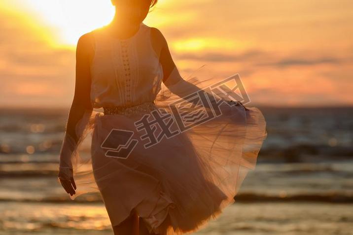 The silhouette of a slim girl in lush pink short skirt, standing