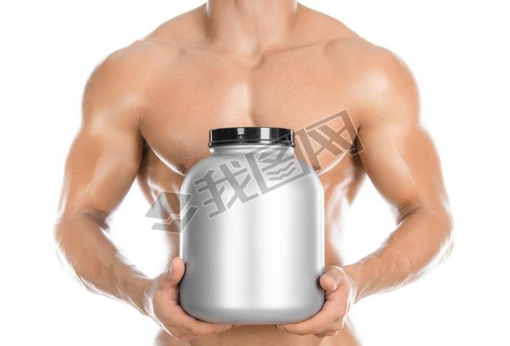 Bodybuilding and Sports theme: handsome strong bodybuilder holding a plastic jar with a dry protein 