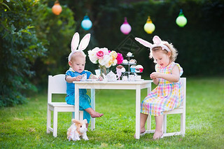 Kids playing Easter tea party with toys