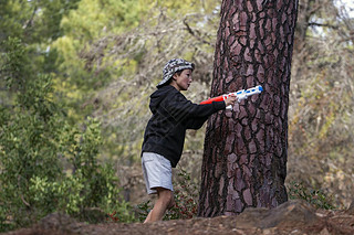 Cute boy with water gun