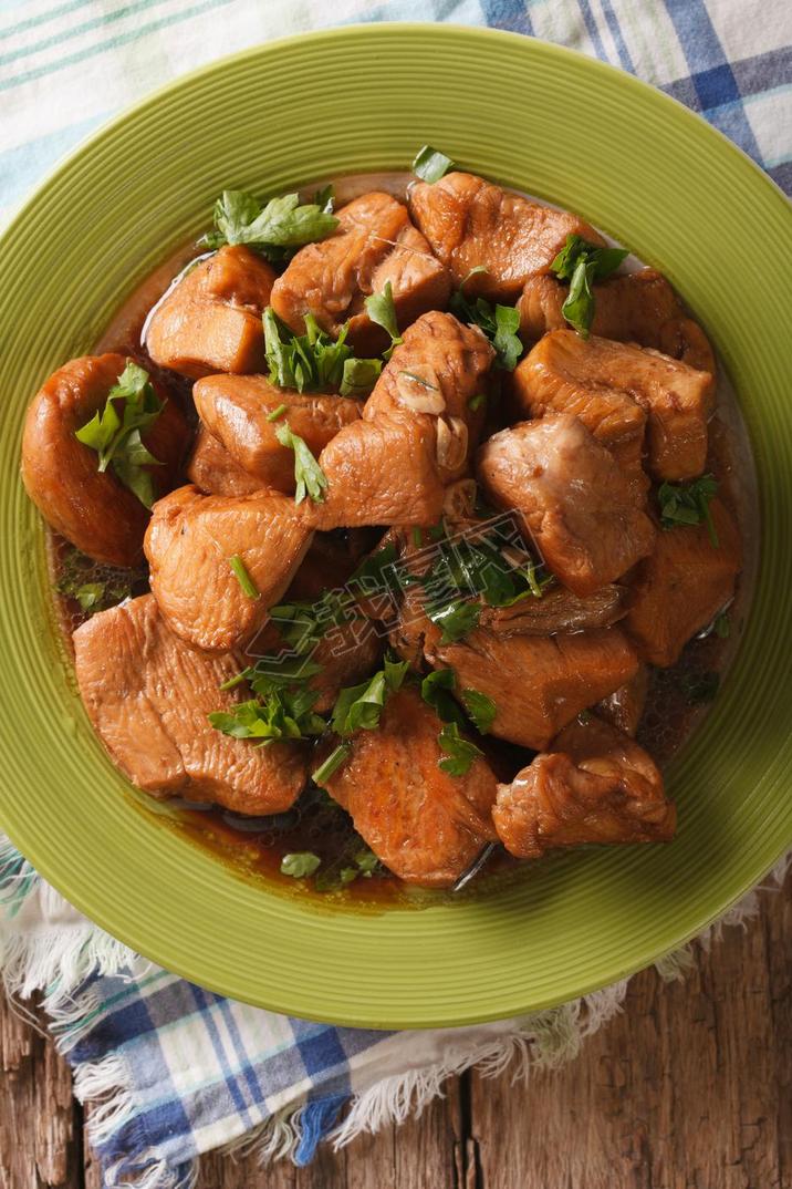 Chicken braised in a sauce Adobo close-up. vertical top view