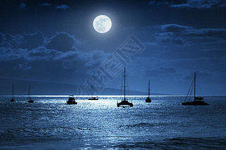 This dramatic photo illustration of a nighttime sky over a calm ocean scene in Maui, Hawaii with bri