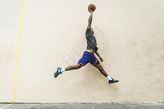 Afro-american basketball player training on a court in New York - Sportive man playing basket outdoo