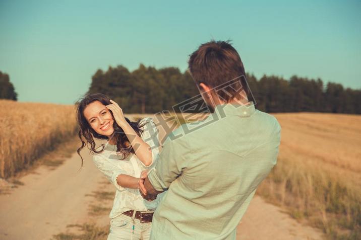 Young couple in love outdoor.in summer in field.le hugging.Young beautiful couple in love stayin