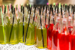 Variety of Sodas in Open Glass Bottles with Straws