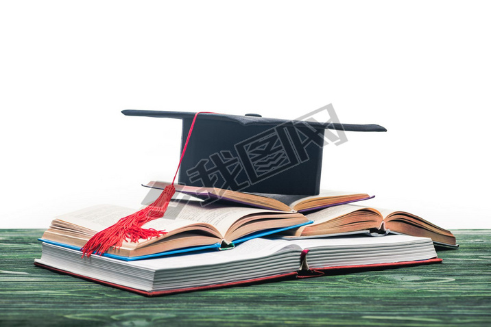 Open books with graduation cap on top