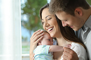 Proud parents holding their baby