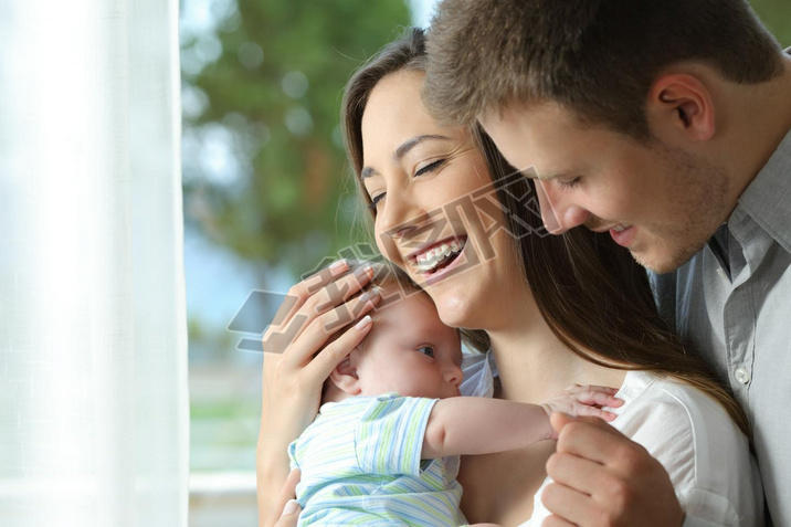 Proud parents holding their baby