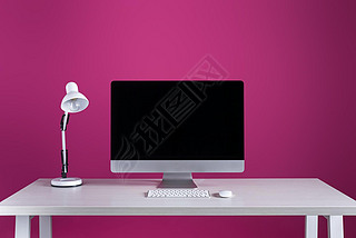 desktop computer with blank screen, keyboard, computer mouse and lamp at workplace