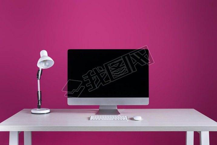 desktop computer with blank screen, keyboard, computer mouse and lamp at workplace
