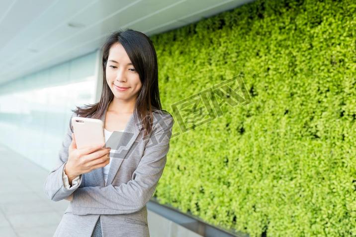 Businesswoman reading on cellphone