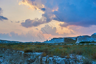 Desert landscape of Gobi Desert, China with a sunset, stones, bushes and the sky. Trel and adventu