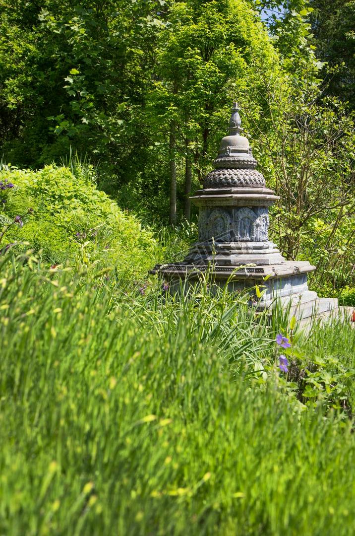 Asian temple like a stupa in the garden. Asiatic background.