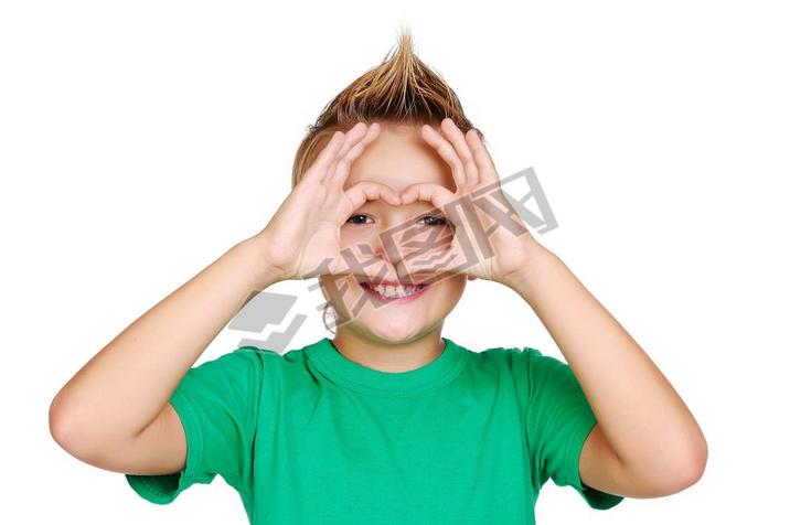 Boy in green tshirt making heart symbol with hands