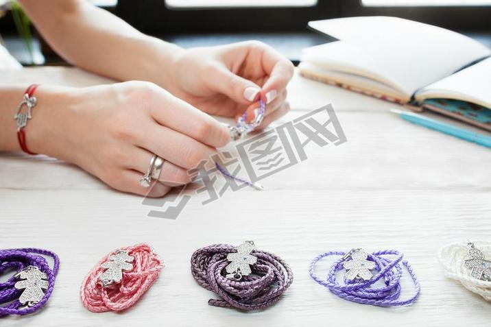 Woman making homemade bracelets