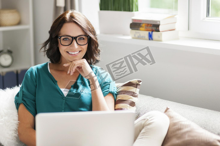 Woman in glasses using laptop