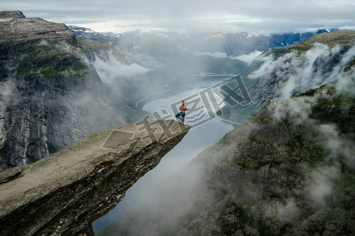 Yog is praying on the edge Trolltunga. Norway