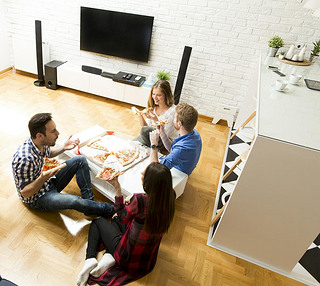 Friends eating pizza in the room