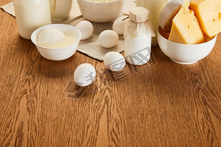 various fresh organic dairy products and eggs on rustic wooden table