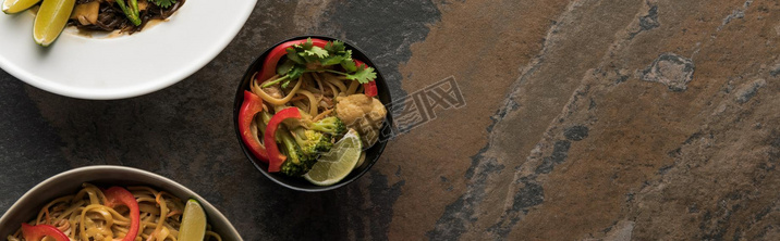 top view of thai noodles with vegetables near chopsticks, panoramic shot