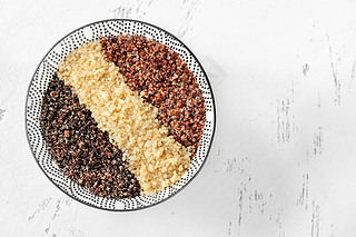 Bowl of white, red and black cooked quinoa