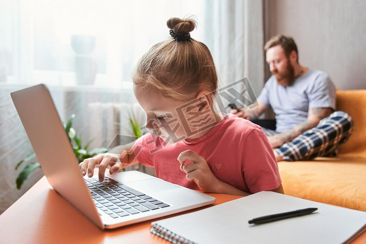 Child is sitting at desk and doing homework