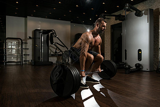 Back Exercise With Barbell In Fitness Center