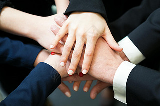 Closeup of pile of hands of business partners