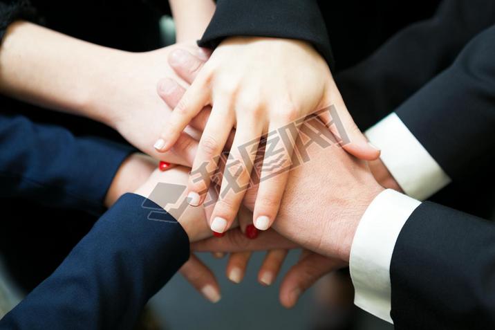 Closeup of pile of hands of business partners