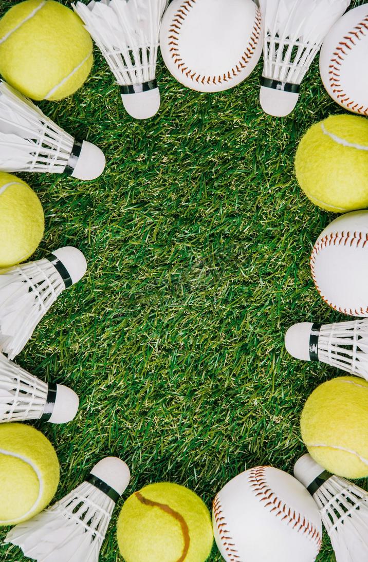 top view of arrangement of badminton shuttlecocks, tennis and baseball balls on green lawn